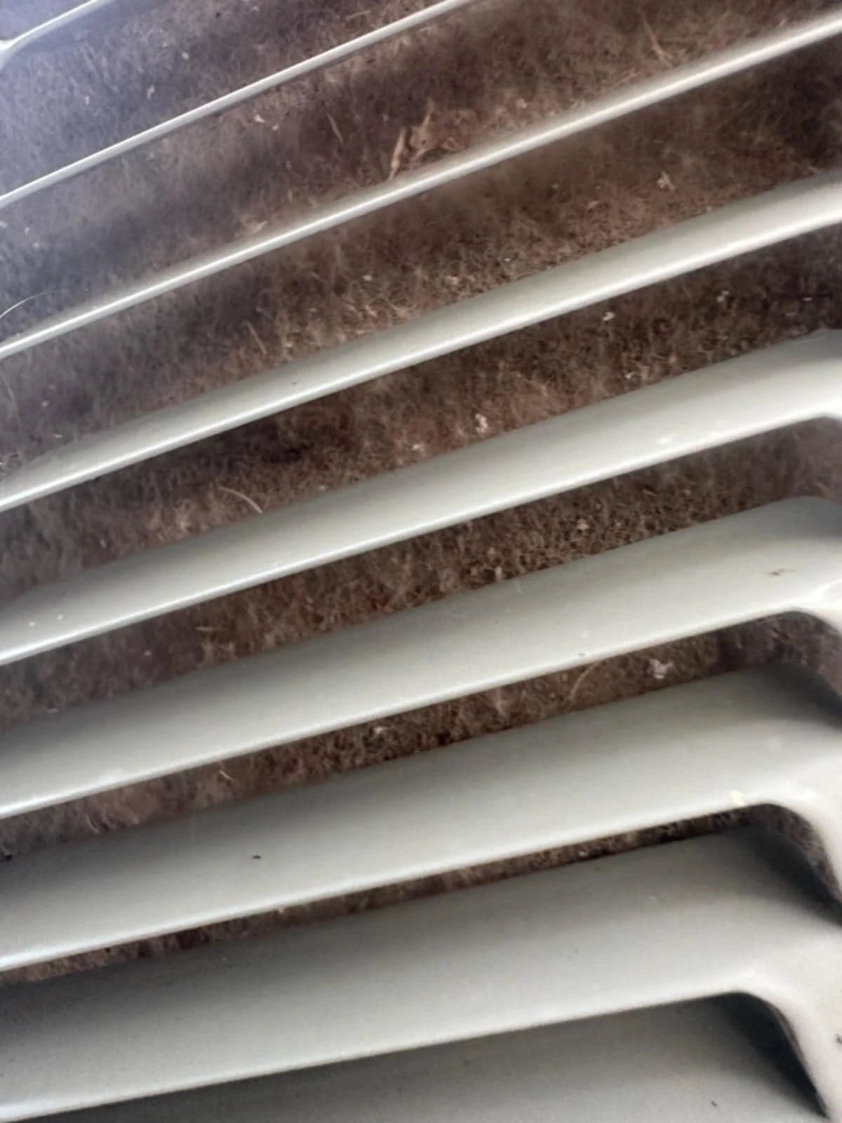 Packed dirty condenser coil in Claremore affecting air quality and HVAC efficiency